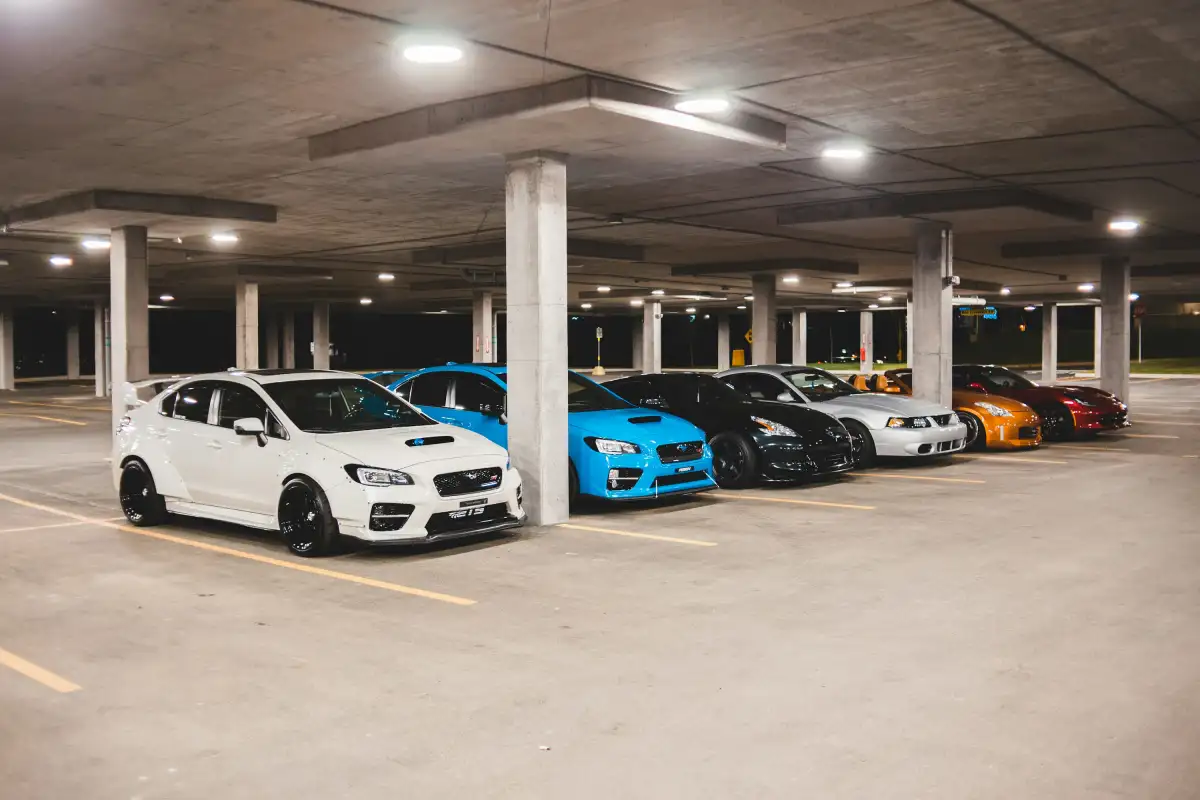 white and blue cars parked on parking lot